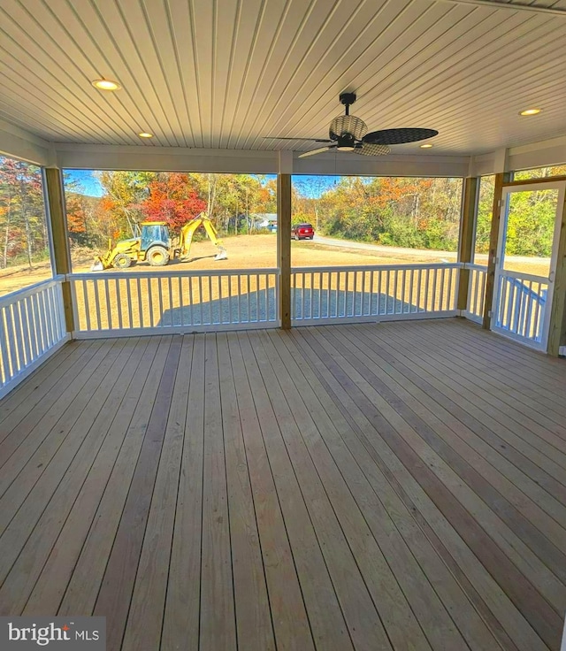 wooden deck with a playground and ceiling fan