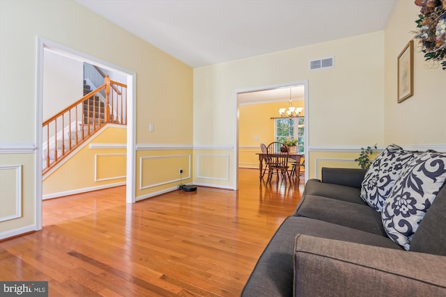 living room with a notable chandelier and hardwood / wood-style flooring