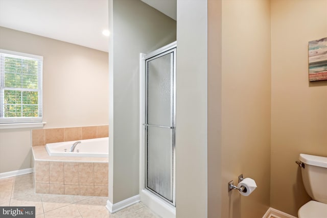 bathroom featuring separate shower and tub, toilet, and tile patterned floors