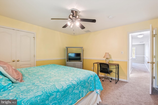 bedroom with a closet, ceiling fan, and carpet