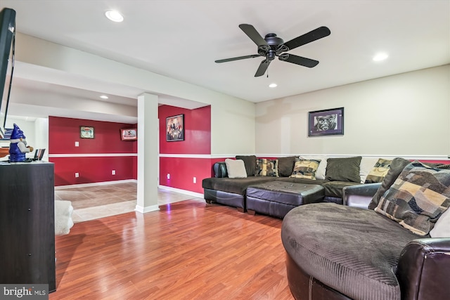 living room with hardwood / wood-style floors and ceiling fan