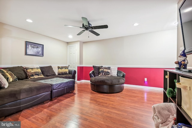 living room featuring hardwood / wood-style flooring and ceiling fan