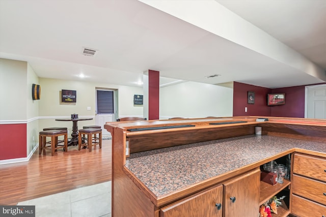 bar featuring light hardwood / wood-style floors