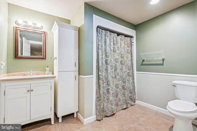 bathroom featuring vanity, a shower with curtain, toilet, and tile patterned flooring