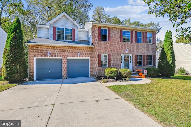 colonial inspired home featuring a front lawn and a garage