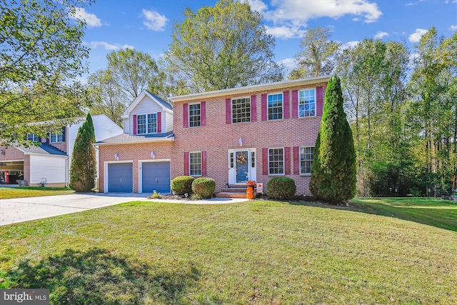 colonial-style house featuring a front lawn and a garage