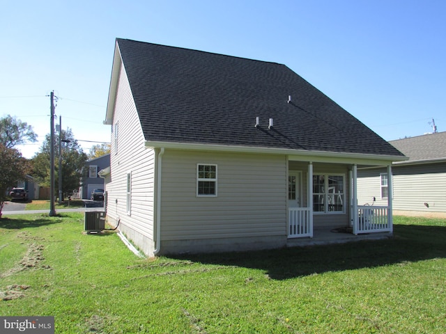 back of house with a porch and a yard