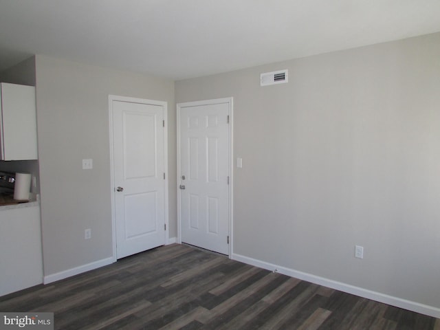 spare room featuring dark hardwood / wood-style flooring