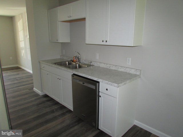 kitchen with dark wood-type flooring, sink, stainless steel dishwasher, and white cabinets