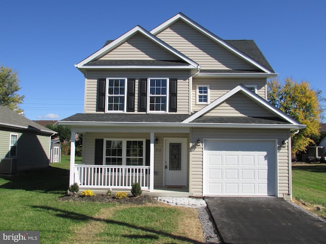 view of front of house with a garage, a front lawn, central air condition unit, and a porch