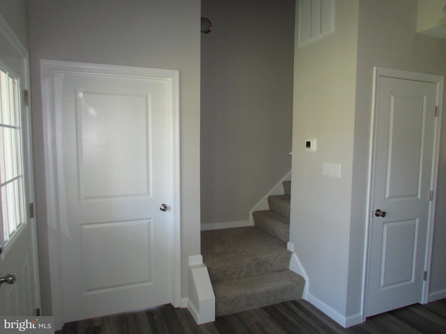 staircase with wood-type flooring