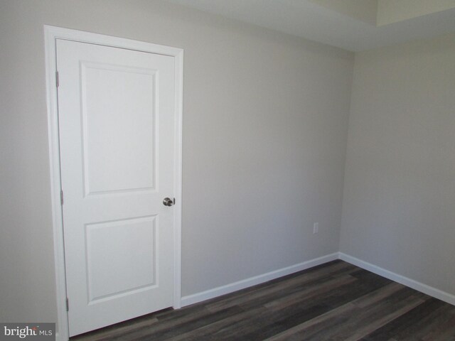 spare room featuring dark hardwood / wood-style flooring