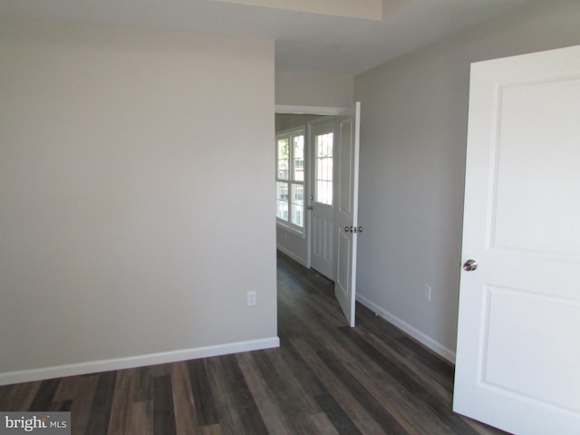 spare room with dark wood-type flooring