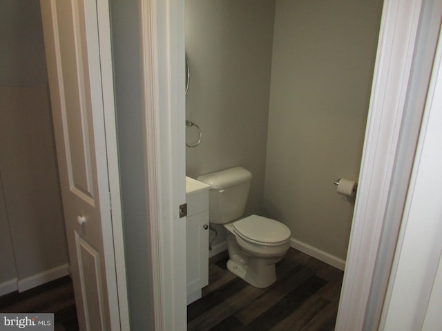 bathroom featuring vanity, hardwood / wood-style floors, and toilet