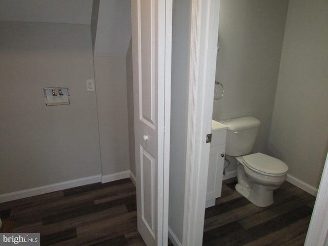 bathroom with toilet and wood-type flooring