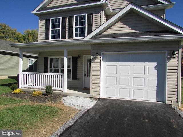 view of front of home featuring a porch and a garage