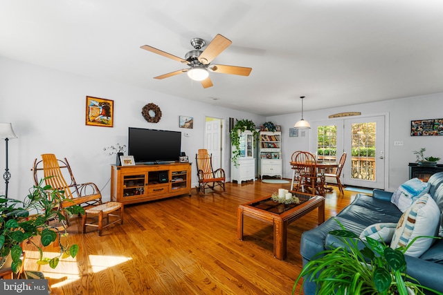 living room featuring light wood-type flooring and ceiling fan