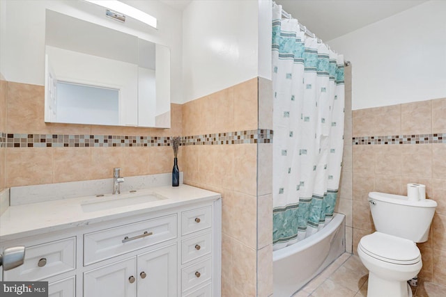 full bathroom featuring tile patterned floors, vanity, toilet, tile walls, and shower / bath combination with curtain