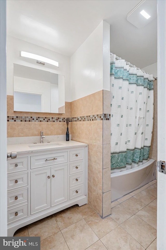 bathroom featuring vanity, shower / tub combination, tile walls, and tile patterned flooring