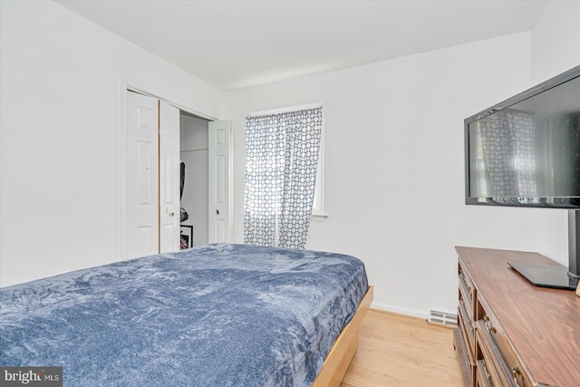 bedroom featuring light hardwood / wood-style floors and a closet