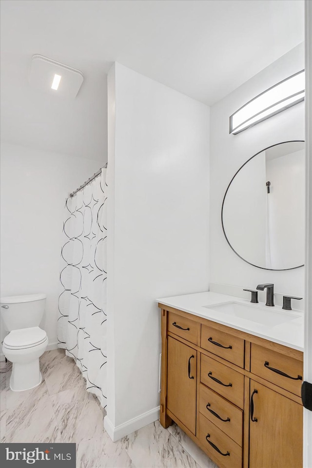 bathroom featuring vanity, toilet, and walk in shower