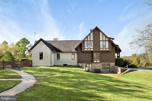 back of house featuring a yard