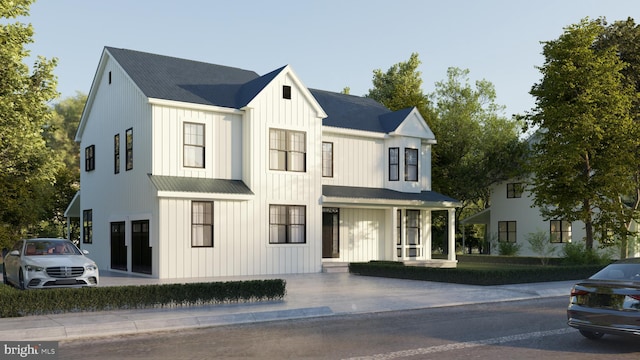 modern farmhouse style home with covered porch, board and batten siding, and metal roof