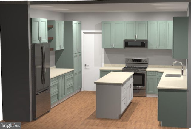 kitchen featuring a sink, a center island, light wood-type flooring, black appliances, and green cabinetry