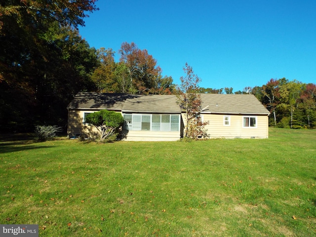 rear view of property with a yard