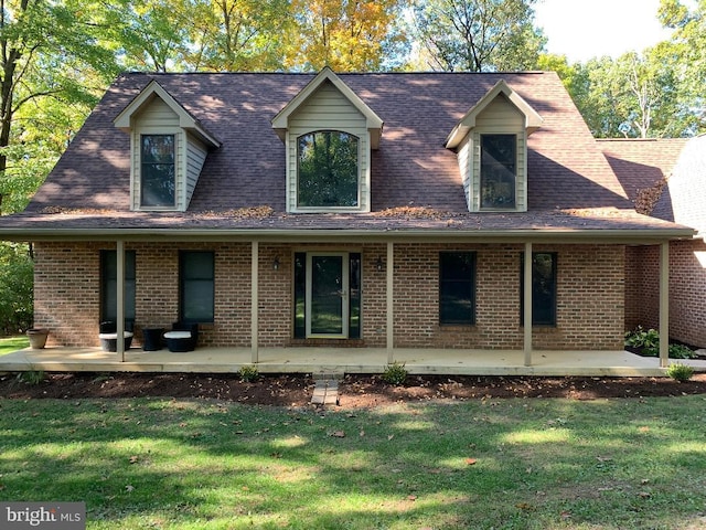 view of front of property with a patio and a front lawn