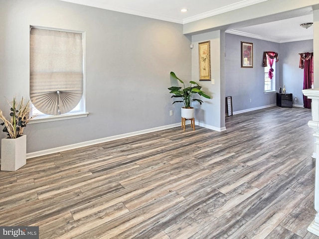 spare room featuring ornamental molding and dark hardwood / wood-style flooring