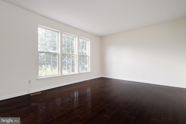 spare room featuring hardwood / wood-style flooring