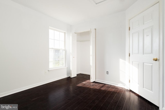 unfurnished bedroom with dark wood-type flooring