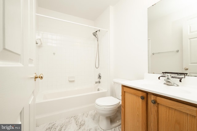 full bathroom featuring vanity, tiled shower / bath combo, and toilet