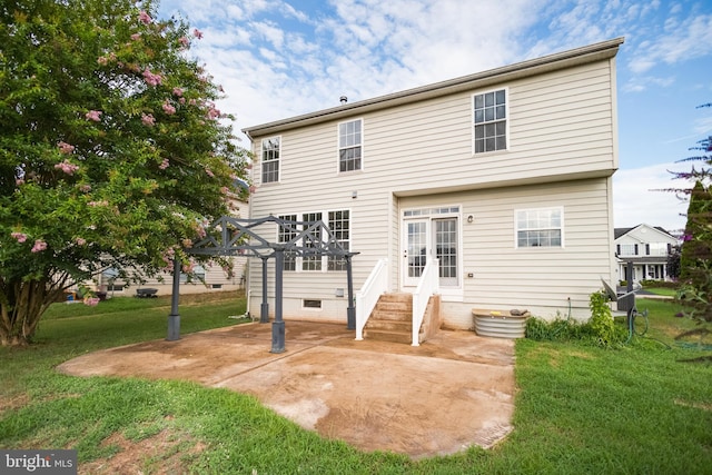 rear view of house featuring a yard and a patio