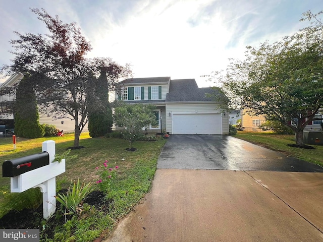 view of front of home with a front lawn and a garage