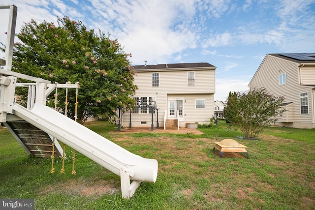 rear view of property with a yard