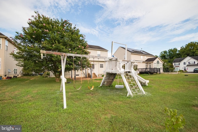 view of jungle gym featuring a deck and a lawn