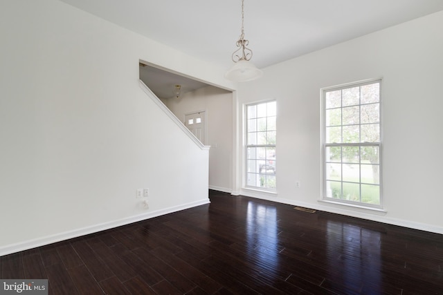 unfurnished room with wood-type flooring