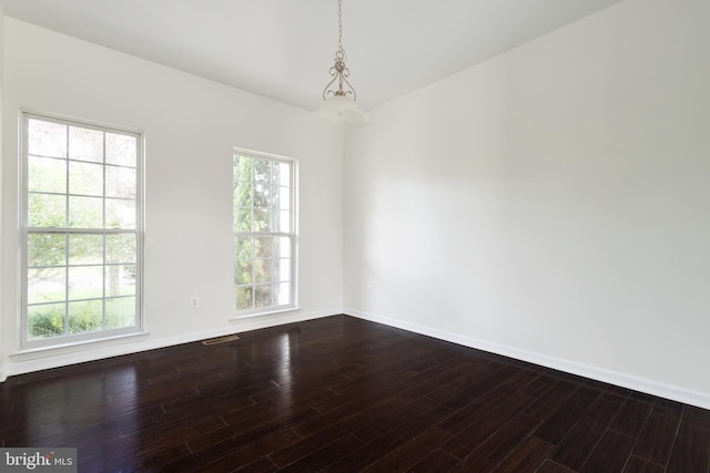 empty room with hardwood / wood-style flooring