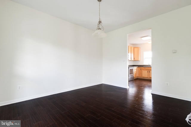 unfurnished room with sink and dark hardwood / wood-style flooring