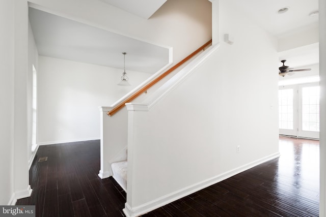 stairs with hardwood / wood-style floors and ceiling fan