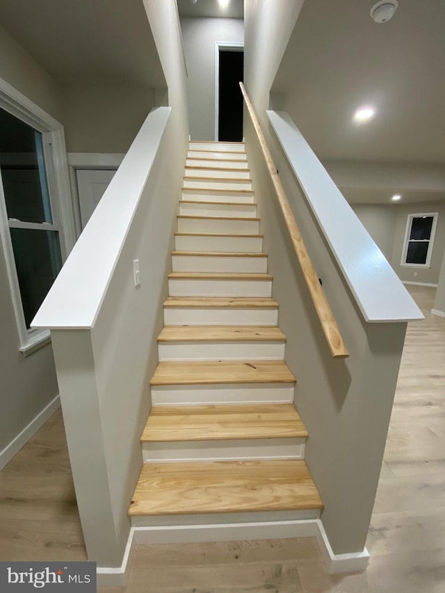 stairs featuring wood-type flooring