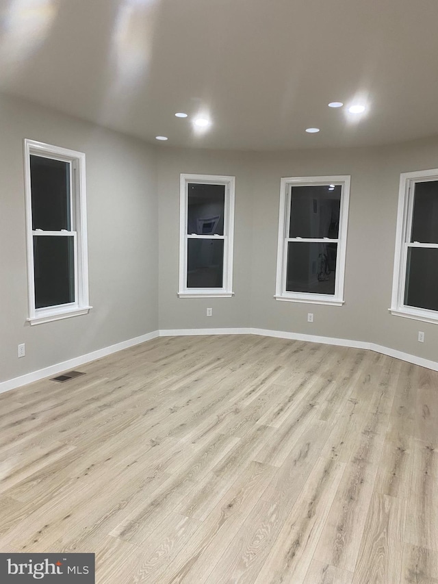 spare room with light hardwood / wood-style flooring