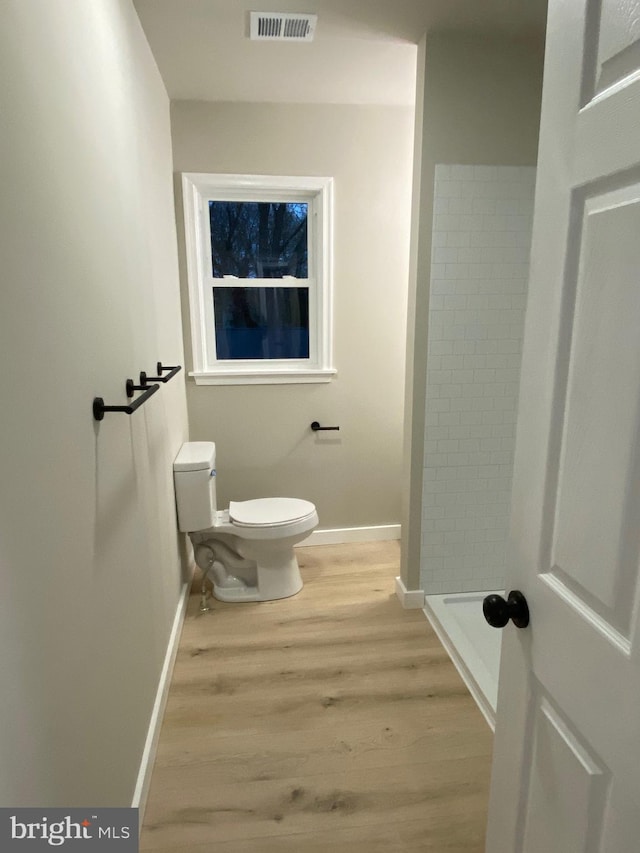 bathroom with wood-type flooring and toilet