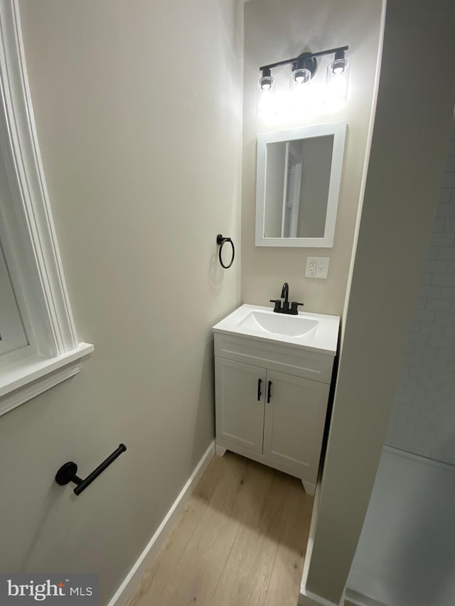 bathroom with hardwood / wood-style floors and vanity