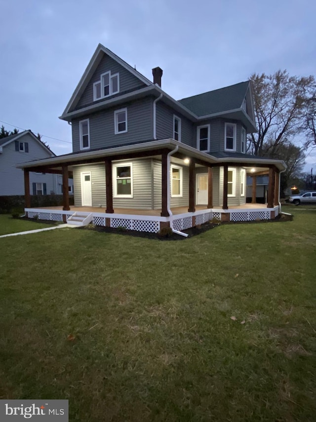 view of front of property with a yard and covered porch