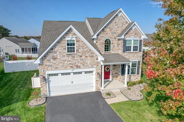 view of front facade featuring a front yard and a garage