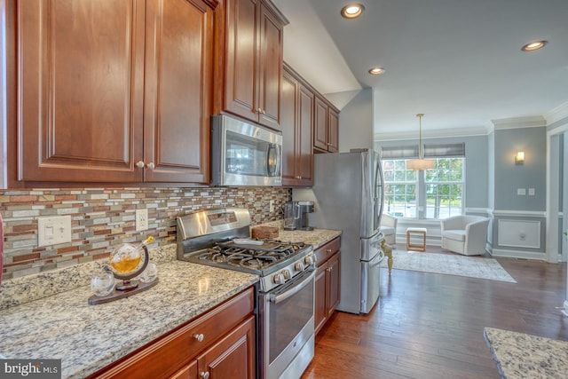 kitchen with appliances with stainless steel finishes, backsplash, light stone counters, crown molding, and dark hardwood / wood-style floors