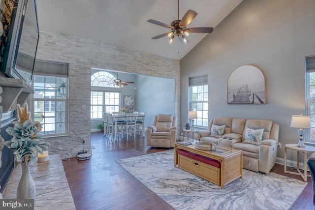 living room with hardwood / wood-style flooring, high vaulted ceiling, and ceiling fan